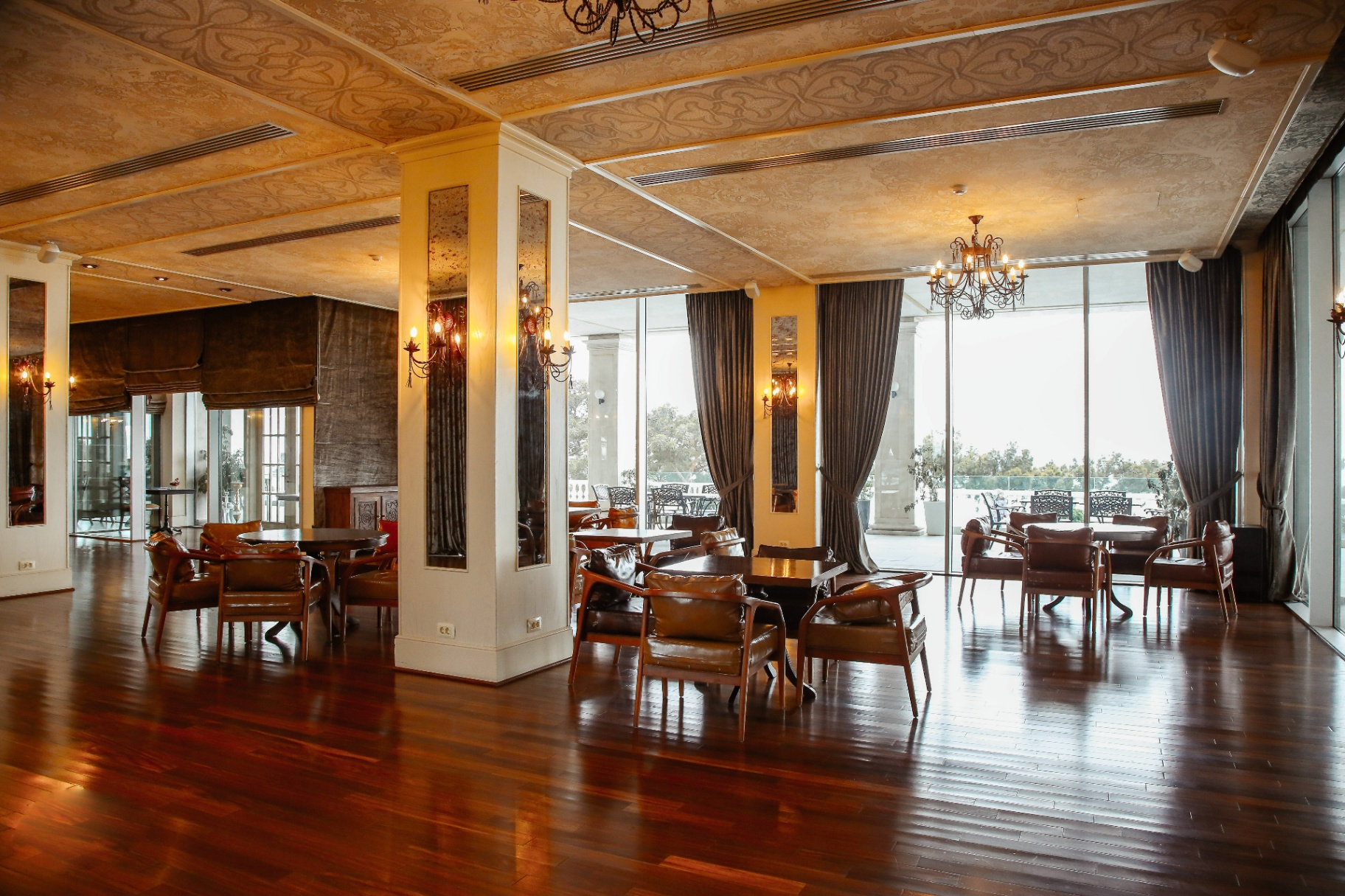 Elegant restaurant lounge with leather armchairs and chandeliers